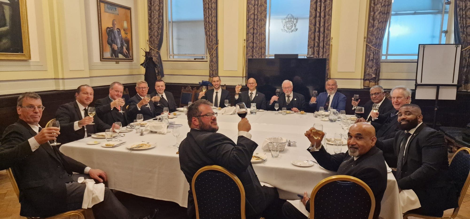 Members sharing a toast at the Festive Board dinner